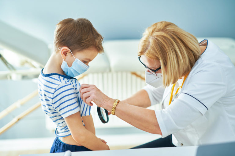 Pediatrician doctor examining little kids in clinic